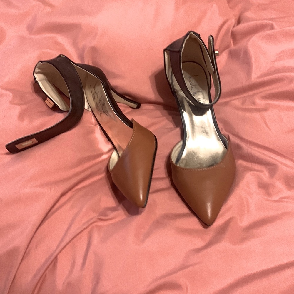 Shoes are light brown & black. They buckle around the ankle with a 3 inch heel.